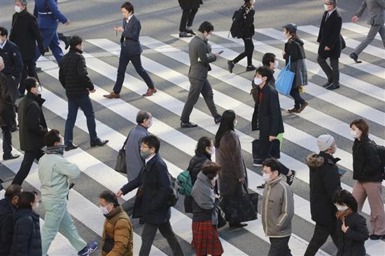 1月13日，佩戴口罩的行人走过日本东京的一处十字路口。新华社 图
